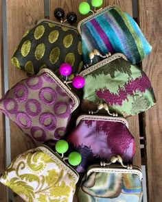 several purses are lined up on a wooden table