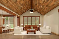 a living room filled with furniture next to a wooden ceiling