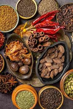 an assortment of spices and nuts arranged in bowls