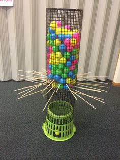 there is a cage with balls in it and sticks sticking out of the top one