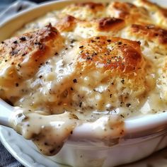 a white bowl filled with food on top of a table