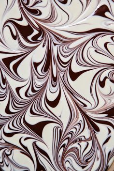 an abstract design made with chocolate and white swirled icing