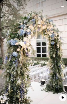 an outdoor ceremony with white and blue flowers