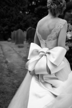 the back of a bride's dress with a large bow