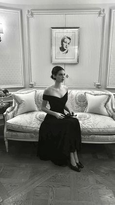 a woman sitting on top of a couch in a living room