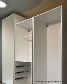 an empty white closet with shelves and drawers