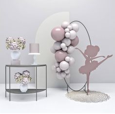 some balloons are hanging on the wall in front of a table with vases and lamps