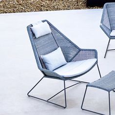 two chairs and a stool sitting on top of a cement floor next to each other