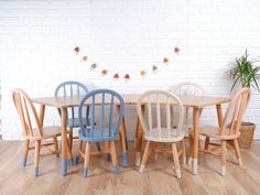 a group of wooden chairs sitting next to each other on top of a hard wood floor