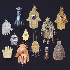 an assortment of handmade items displayed on a black surface with one being a hamsa and the other is a pair of gloves