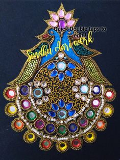 an intricately designed broochle with colorful stones and pearls on it's side