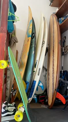 several surfboards are lined up against the wall