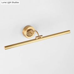 an image of a bathroom light fixture with gold finish on the wall and white background