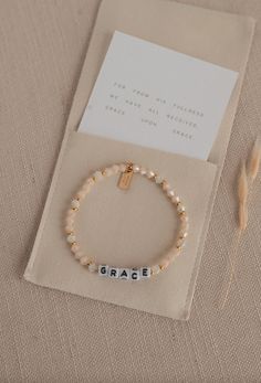 Size: 6.75" one size fits most! Details: -beaded stretch bracelet -verse reference on attached gold tag -Microfiber pouch with "From His Fullness We Have Received Grace Upon Grace" stamped onto the outside -tiny cotton card with scripture reference inside the pouch with bracelet Diy Faith Jewelry, Beaded Word Bracelet, Jesus Bracelet Ideas, Christian Bracelet Ideas, Jesus Accessories, Xmas Bracelets, Jesus Jewelry, Christian Jewelry For Women, Jesus Bracelet