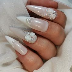 Elegant and ethereal, these wedding nails are a true work of art. Soft, pastel hues blend seamlessly with delicate floral designs, creating a dreamy and romantic look that will complement any bridal ensemble. Each nail is meticulously adorned with intricate details that exude beauty and grace, adding a touch of sophistication to the bride's overall appearance. With these stunning nails, the bride is sure to feel like a true princess on her special day. Pretty Wedding Nails Brides, Wedding Nails And Toes For Bride, Nail Bride Wedding, Ivory Wedding Nails For Bride, 3d Wedding Nails, Bridal Nails Floral, Wedding Almond Nails For Bride, Nail Designs Bride, Brides Nails For Wedding