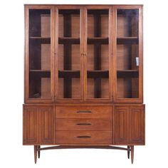 a wooden cabinet with glass doors and drawers on the front, against a white background