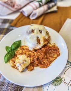 a white plate topped with meat covered in gravy