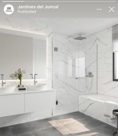 a bathroom with white marble walls and floors