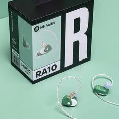 two ear buds are sitting in front of a box