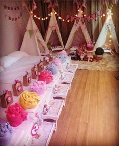 a long table filled with lots of cupcakes on top of wooden flooring