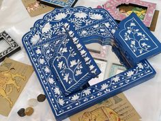 several different types of decorative items on a white tablecloth with paper cutouts in the shape of animals and flowers