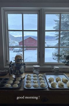 a kitchen counter topped with donuts and muffin tins next to a window