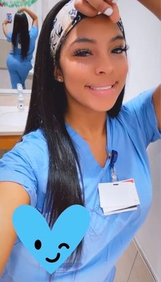 a woman with long black hair wearing a blue scrub