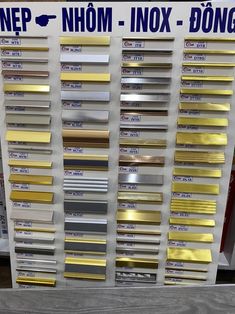 an assortment of metal sheets on display in a store with price tags and prices below them