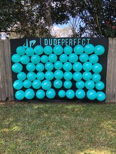 blue balloons are arranged in the shape of a large number on a black sign that says dudeperfect