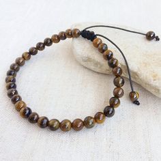 This Wrist Tasbih bracelet is made with 6mm Tigers eye beads. 33 beads used for dhikr and remembrance of Allah. Ideal gift for men or women. This bracelet is adjustable for wrist sizes between 7.5-9 inches. This tasbih has 8 inche inside diameter. Tiger's Eye is known as a protective stone traditionally carried as a talisman against ill wishing and curses it shows to how to correctly use the power given to you. Tiger Eye assists in accomplishing goals, recognizing inner resources and urging clarity of intention. It is an excellent stone to take with you for exams and important meetings. Tiger Eye will increase feelings of self-worth, overcome the habit of self-criticism and clear blocked creativity. Tiger balances the lower chakras, balances Yin and Yang and energizes the emotions. It ease Brown Braided Bracelets With 8mm Beads, Adjustable Brown Rosary Bracelet For Meditation, Adjustable Evil Eye Bracelet With Gemstone Beads, Casual Adjustable Rosary Bracelet With 8mm Beads, Adjustable Evil Eye Bracelet With 8mm Beads, Adjustable Spiritual Evil Eye Bracelet With Round Beads, Casual Adjustable Evil Eye Bracelet With Round Beads, Tasbih Bracelet, Tigers Eye Bracelet