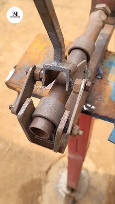 an old metal object sitting on top of a wooden table