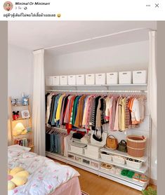 an organized closet with clothes and shoes on the shelves next to a bed in a bedroom