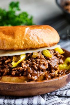 a close up of a sandwich on a plate with meat and vegetables in it,