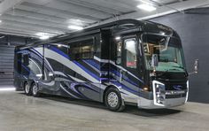 a black and silver bus parked in a garage