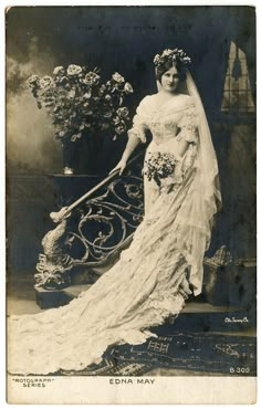 an old black and white photo of a woman in a wedding dress