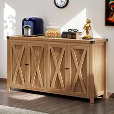 a wooden cabinet with a clock on the wall above it and other items sitting on top of it