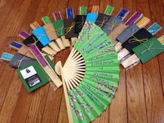 a green fan sitting on top of a wooden floor next to books and other items