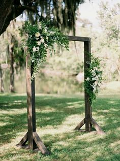 an outdoor ceremony setup with flowers and greenery