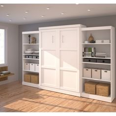 a white bookcase with drawers and file cabinets