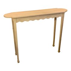 a wooden table with scalloped legs and a curved top on an isolated white background