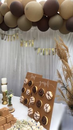 desserts are displayed on a table with balloons in the background