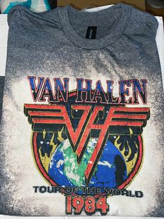 the van halen tour of the world 1994 t - shirt is displayed on a table