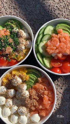 three white bowls filled with different types of food on top of a stone floor next to each other