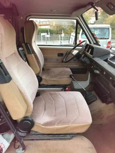 the interior of a vehicle with beige seats