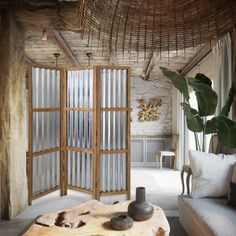 a living room filled with furniture next to a large wooden table covered in glass doors