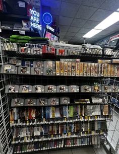 there are many video games on display in the store, and one is for sale