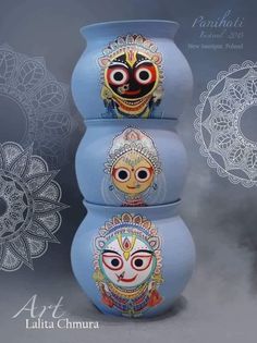 three blue vases with faces painted on them and an ornamental design behind the two