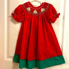 Never Worn But Tag Was Removed Super Pretty Christmas Dress With Wonderful Smocked Details On Collar And Sleeves Could Easily Fit Up To Size 3 Because Of The Traditional Length! Red Embroidered Christmas Dress, Red Embroidered Dress For Christmas, Red Smocked Dress With Ruffles And Short Sleeves, Red Holiday Dress With Smocked Bodice, Red Smocked Bodice Dress For Holiday, Red Smocked Short Sleeve Dress, Holiday Dresses With Smocked Back, Festive Short Sleeve Holiday Dress For Christmas, Red Short Sleeve Holiday Dress