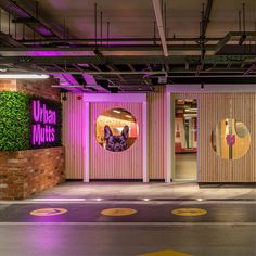 the entrance to an office building with purple lighting and wood panels on the walls, in front of a brick wall