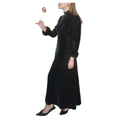 This vintage 1940s bias-cut velvet dress is the black velvet dress your wardrobe is missing— it is just SO good. It was made in the 1940s of black velvet with a gorgeous bias cut; that cut, combined with the high inverted-V waist, create the most gorgeous shape that flatters everyone. The sleeves are trimmed with faux-fur, and I love the chic mock neck. Closes in the back with a zipper and snap. Measurements: Best fits a size X-Small and Small; it's more narrow through the shoulders and hips and Maxi Dress Black, Black Velvet Dress, Vestidos Vintage, Velvet Dress, Fur Trim, New Vintage, Black Velvet, Day Dresses, Mock Neck